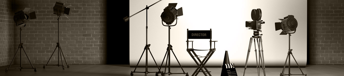 Black and white photo of a directors chair and lights