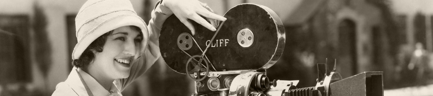 Vintage photo of a woman operating a film camera.